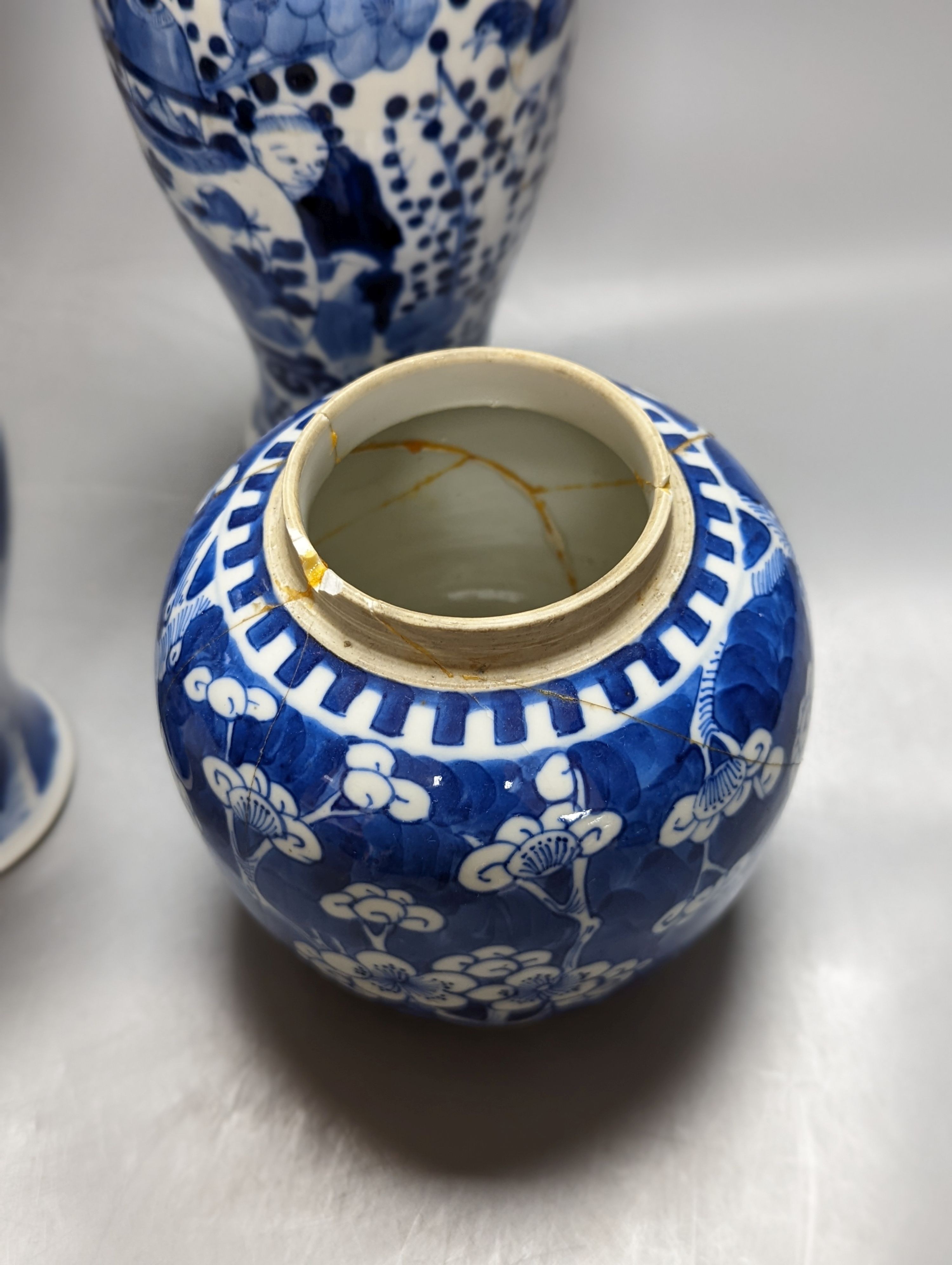 A pair of 19th century Chinese blue and white vases, a prunus vase and cover and a similar jar (4), pair of vases 24 cms high.